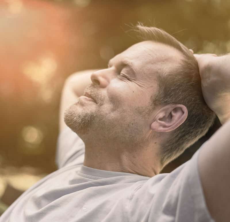 Advertisement for Whitney Sleep Home Sleep Tests features man relaxing outside.