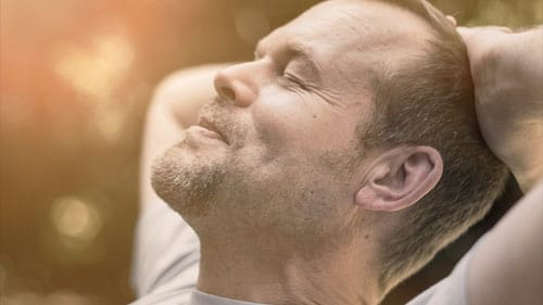 An advertisement for Whitney Sleep features a man smiling as he relaxes with his head in his hands. Whitney Sleep Center in Plymouth, Minnesota ensures "Better sleep. Better life."