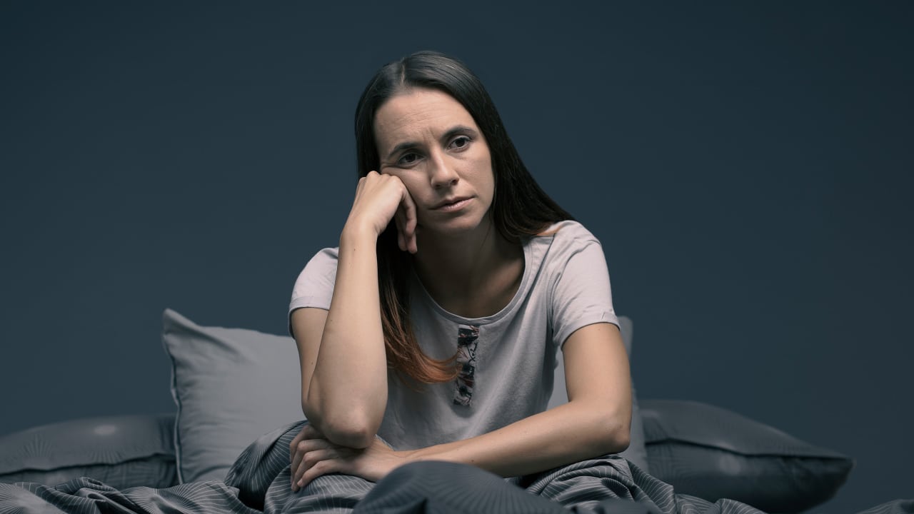 A tired woman up at night - 5 Tips for Better Sleep