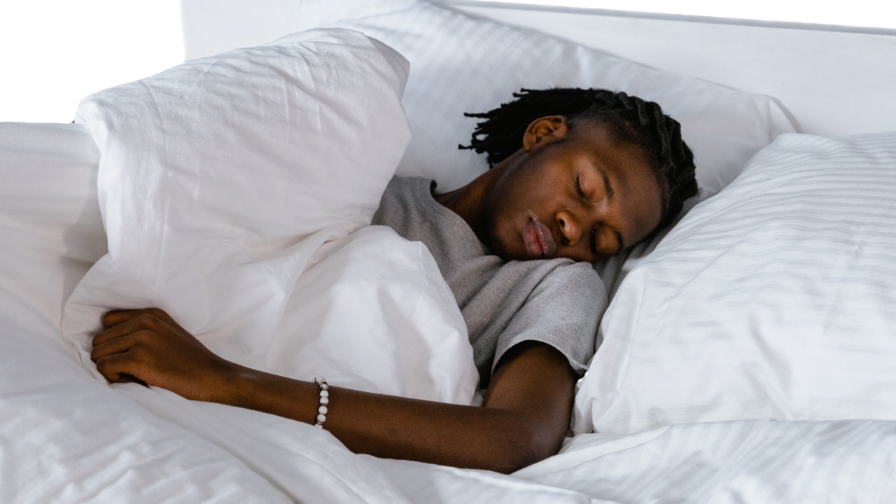 man sleeping in a bed