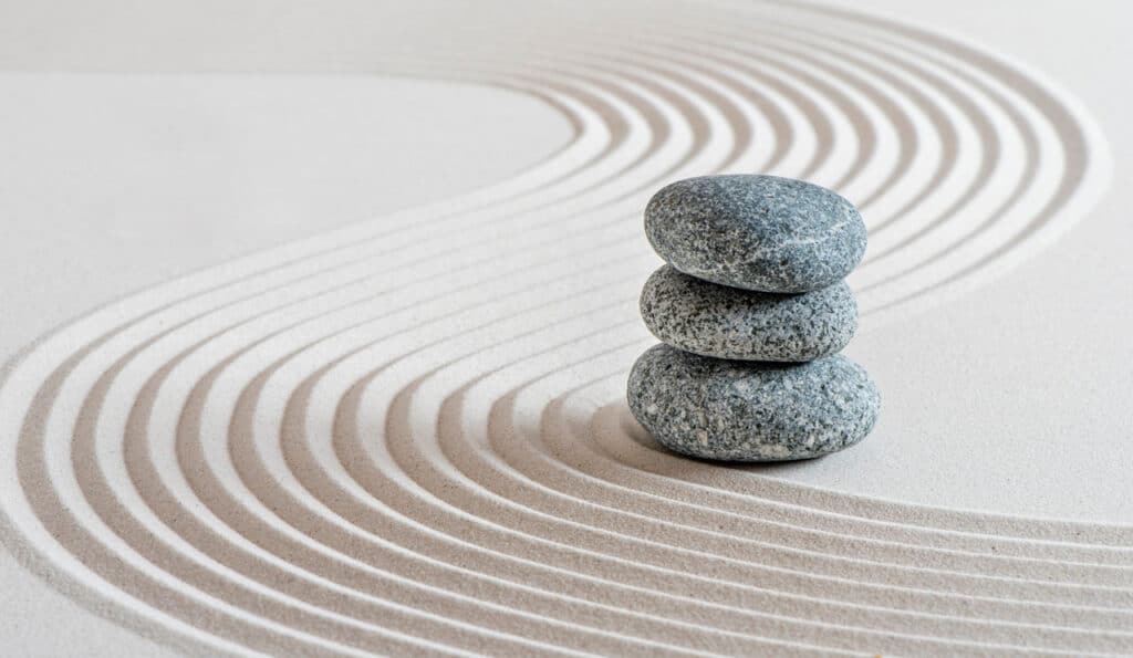 Stacked zen stones on sand ground