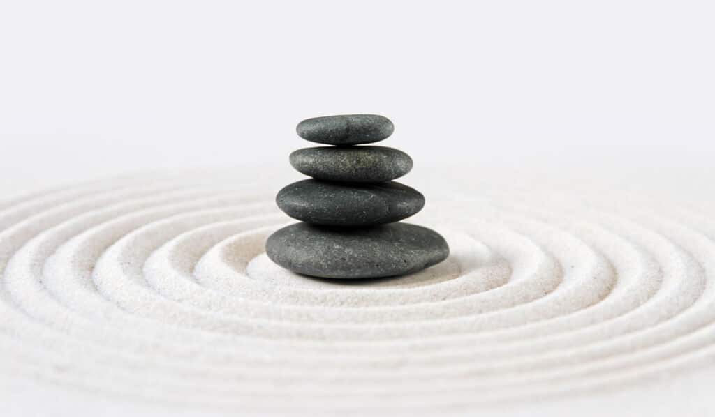 Stacked zen stones on sand ground