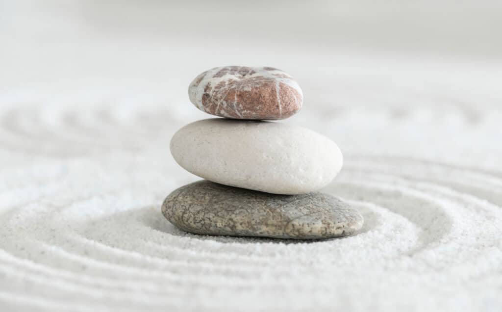 Stacked zen stones on sand ground