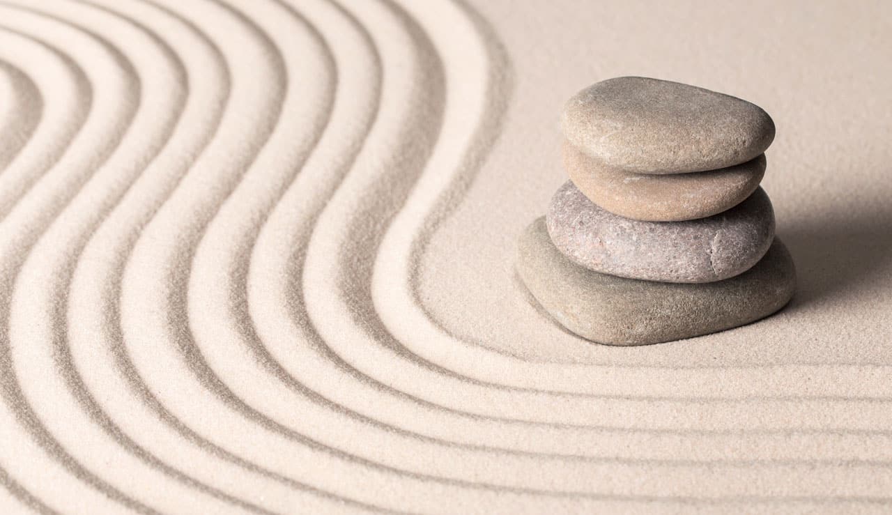Stacked zen stones on sand ground
