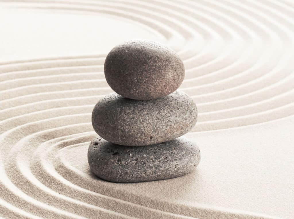 Stacked zen stones on sand ground