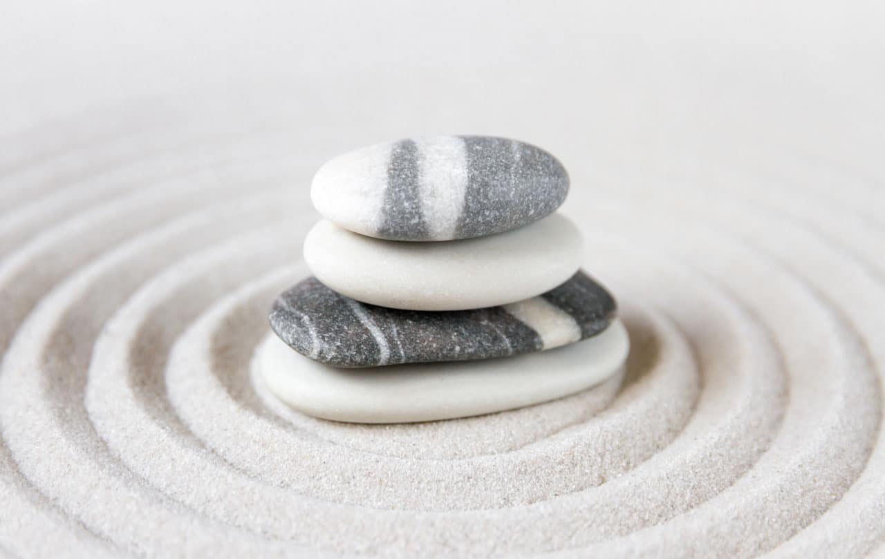 Stacked zen stones on sand ground